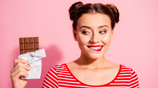 picture of a woman looking at a chocolate bar