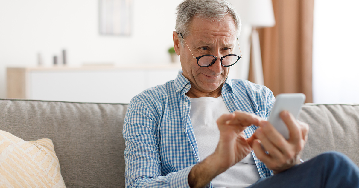 Older man squinting at his phone