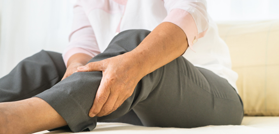 picture of a woman holding her leg