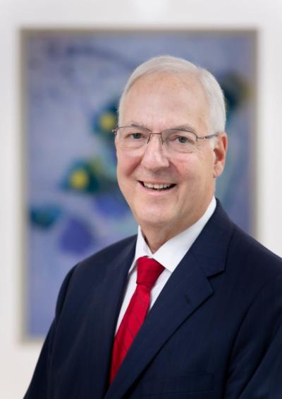 Kenneth Cowan, MD, PhD, pictured with one of his cancer patients.