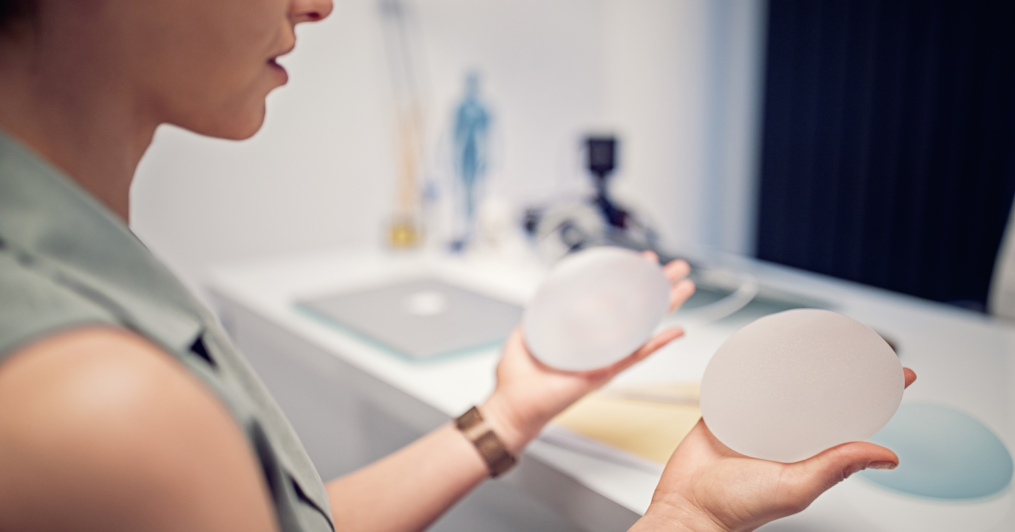 Woman holding breast implants