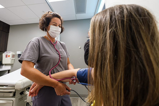 A nurse taking a patient's blood pressure. 