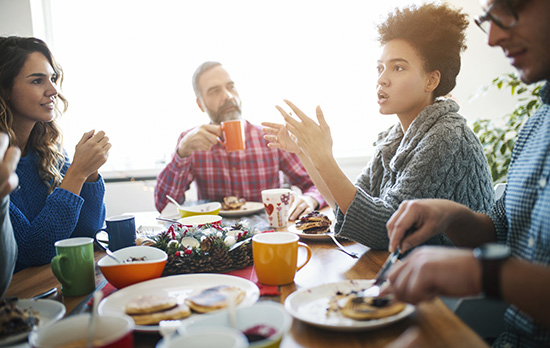 A family talking over a holiday dinner.