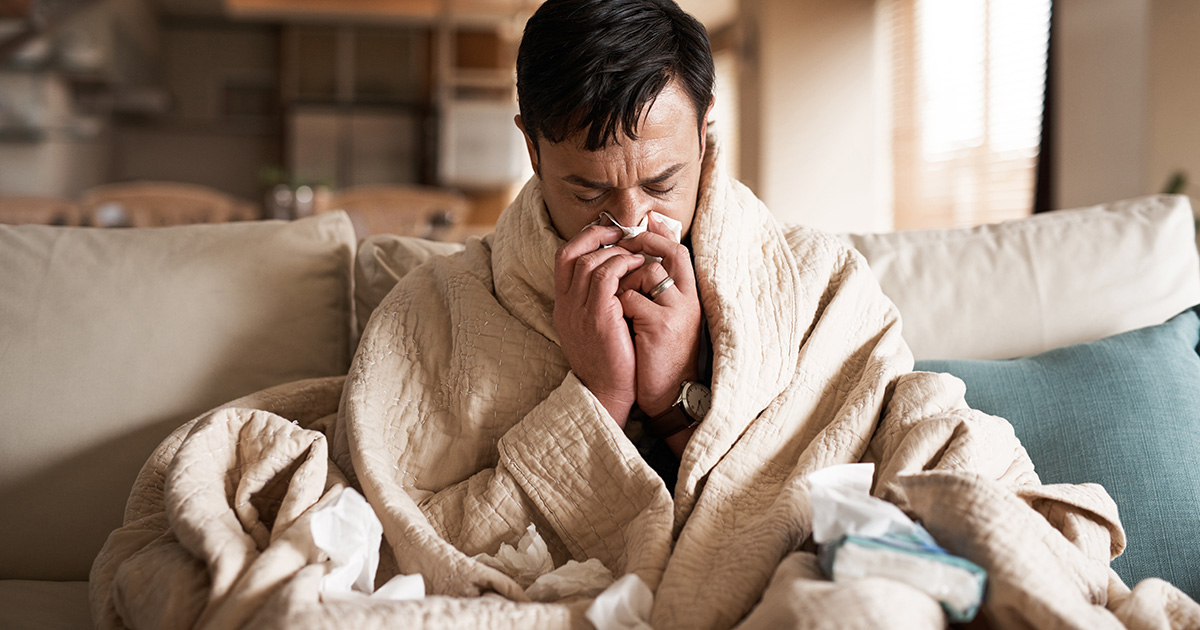 Man sick blowing his nose