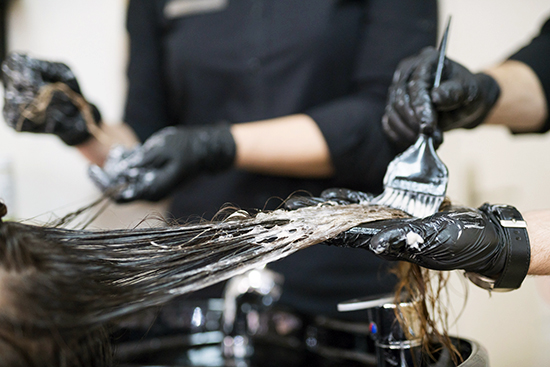 A woman having her hair dyed. 