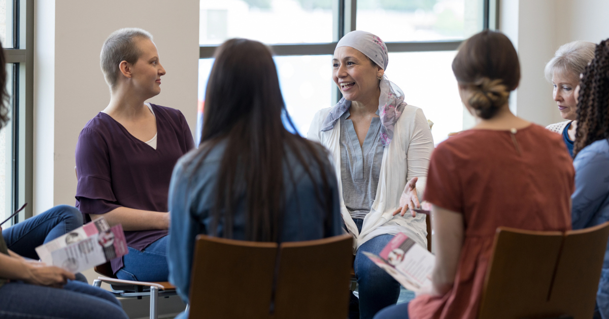 Woman with a headscarf talking in a support group