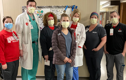 Mary's care team was thrilled to see her again in 2022 and hear about her book. Pictured to the right of Mary (center) in the white coat is Nutrition Therapist Nikki Spurgeon, MS, RD, LMNT. "Mary is a special person in so many ways," says Spurgeon. "What I remember most about her journey was her positive outlook, even during the most difficult times."