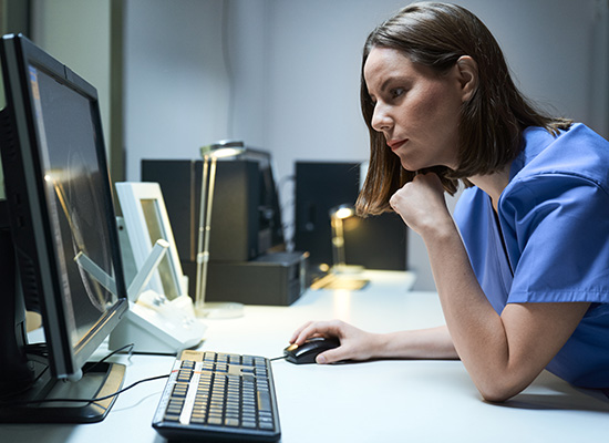 Nurse staring intently at a screen