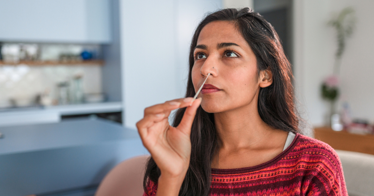 Woman swabbing her nose