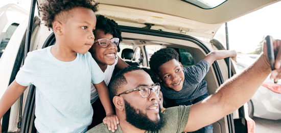 Black family taking picture while on vacation.