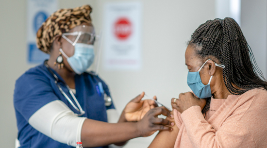 picture of a woman getting COVID-19 booster vaccine