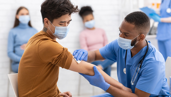 picture of a young man getting his COVID-19 vaccine