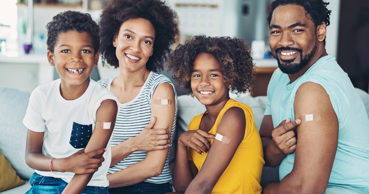 Family with vaccine bandages