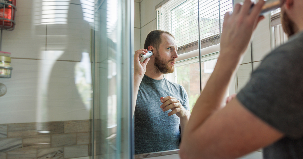 Man trimming his ear hair