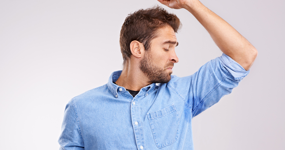 picture of a man noticing his underarm smell