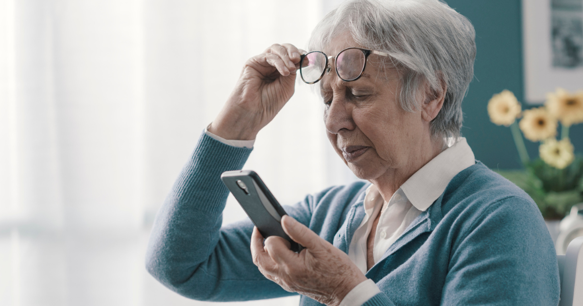 Older woman squinting at her phone