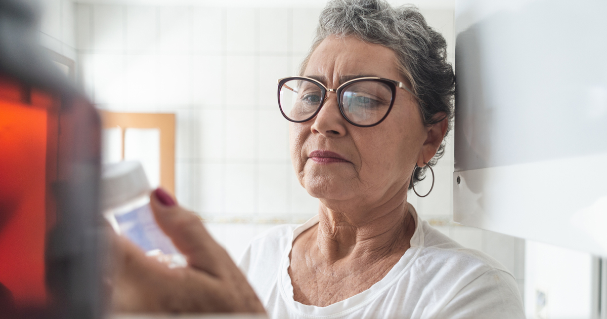 Older woman holding a pill bottle