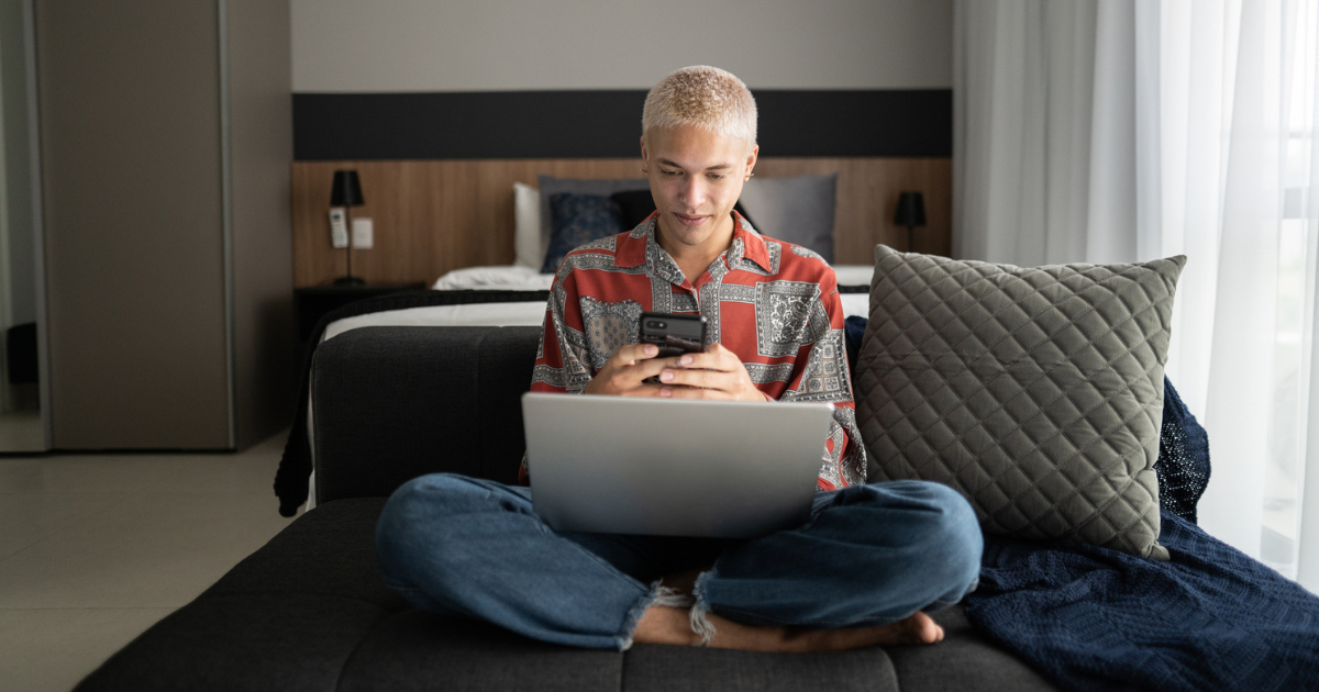 Man sitting on the couch looking at his phone