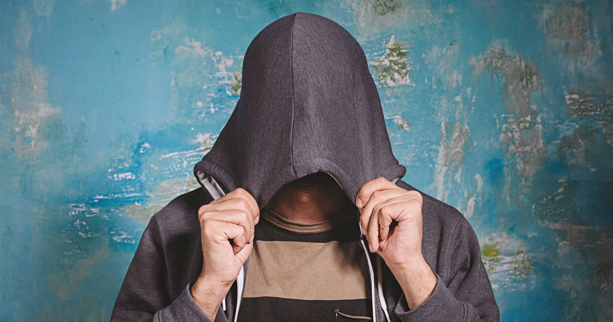 Man hiding his face in a hood