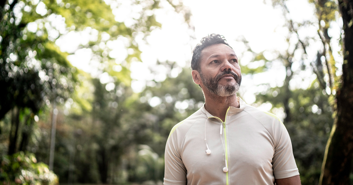 A middle-aged man walking in the woods