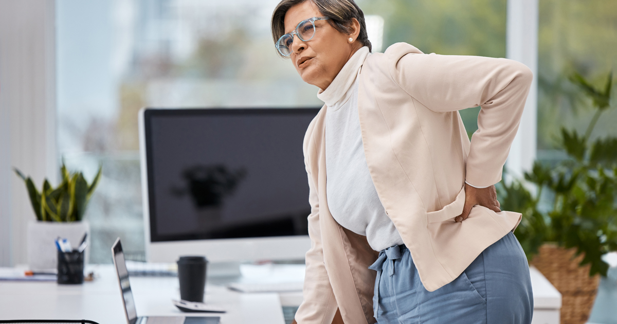 Woman holding her lower back in pain