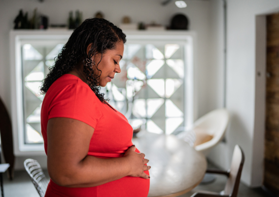 Pregnant woman holding her belly