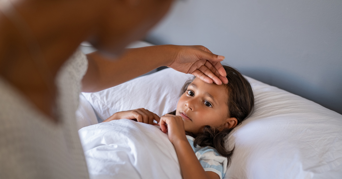 A young girl sick in bed