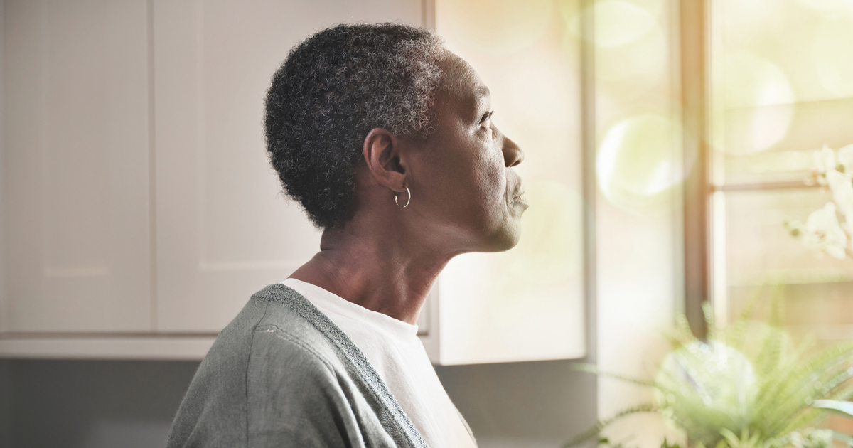 Older woman looking out a window