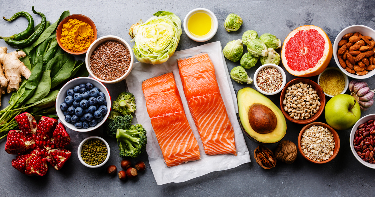 Salmon surrounded by fruits and vegetables