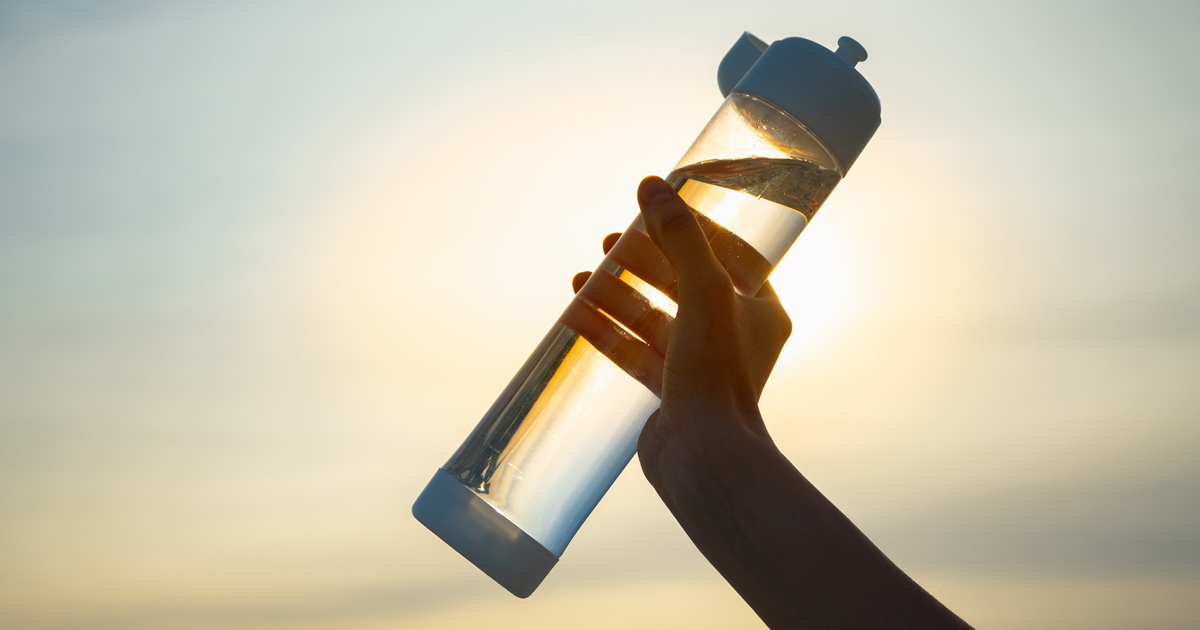 Close up of a hand holding a water bottle