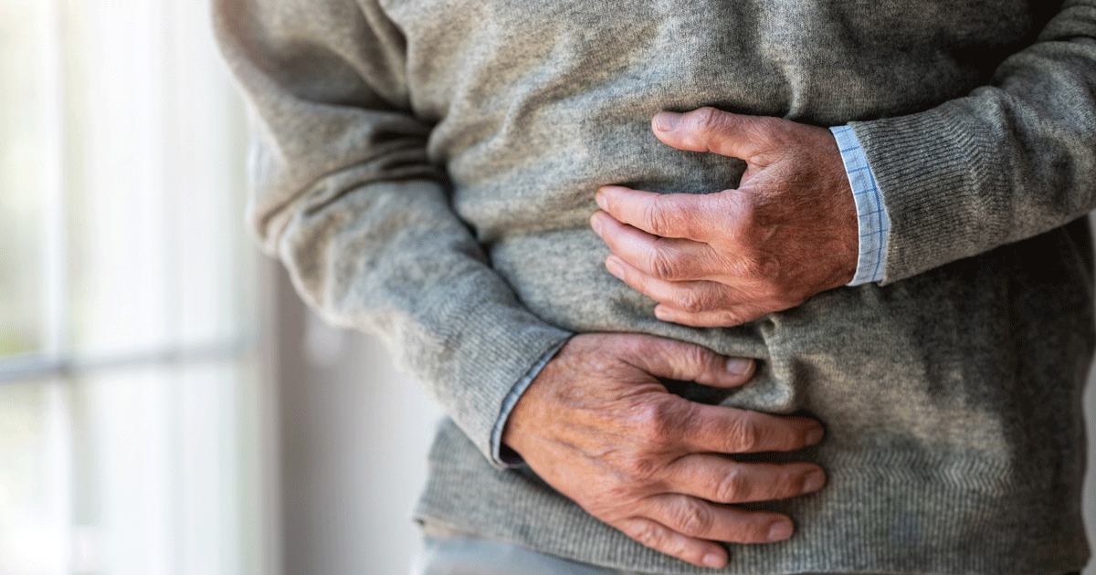 Close up of a man grabbing his stomach