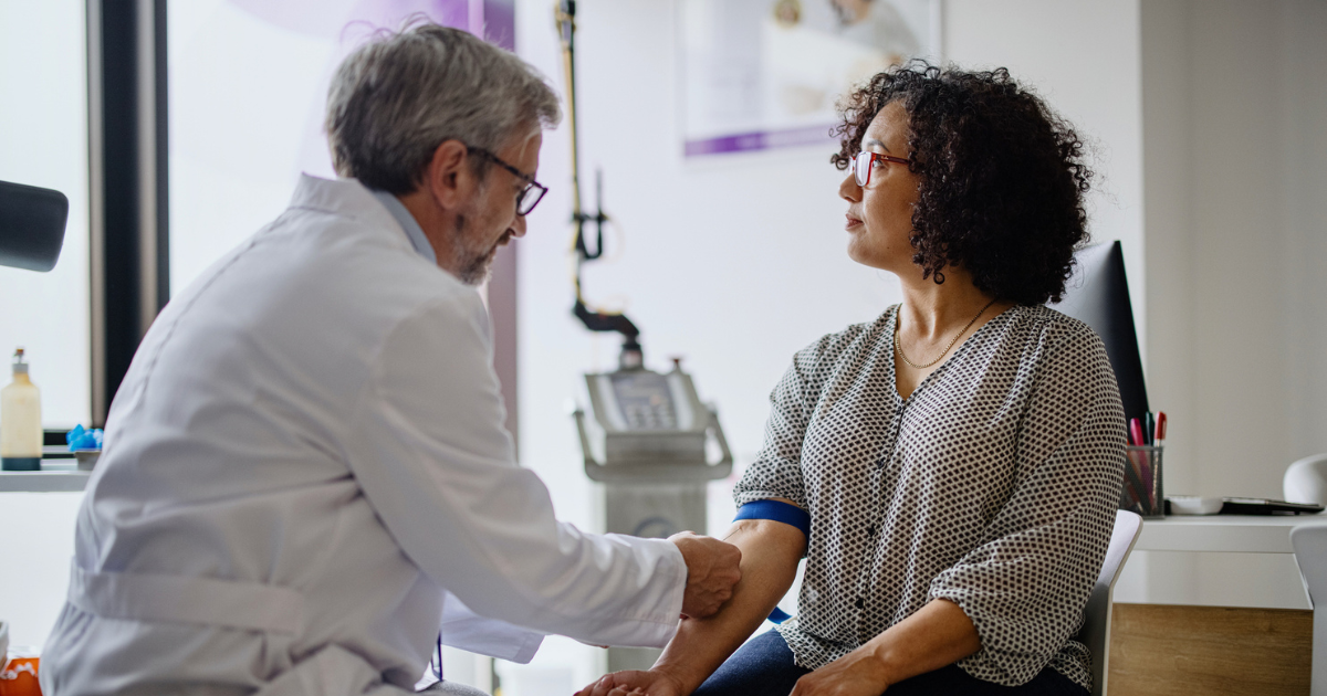 Woman getting her blood drawn by her doctor