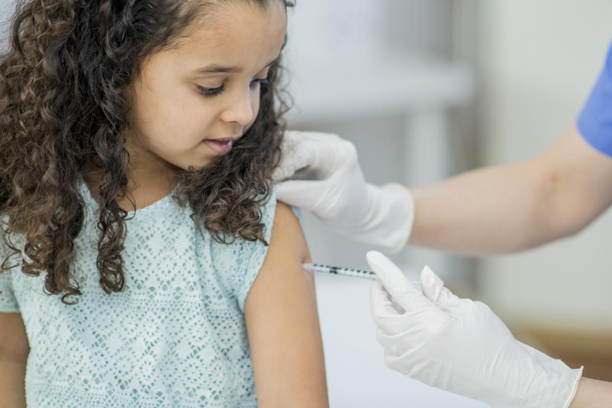 A young girl receiving a vaccination.