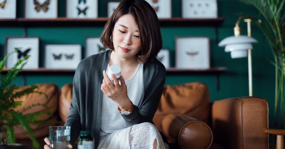 Woman reading a pill bottle