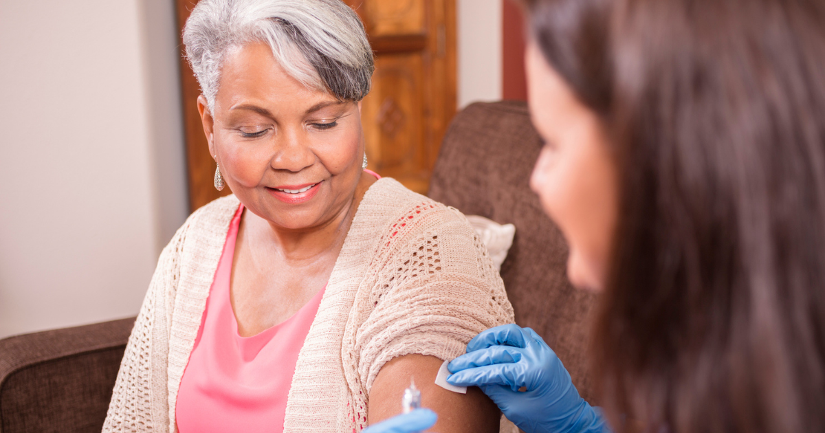 Older woman receiving a shot