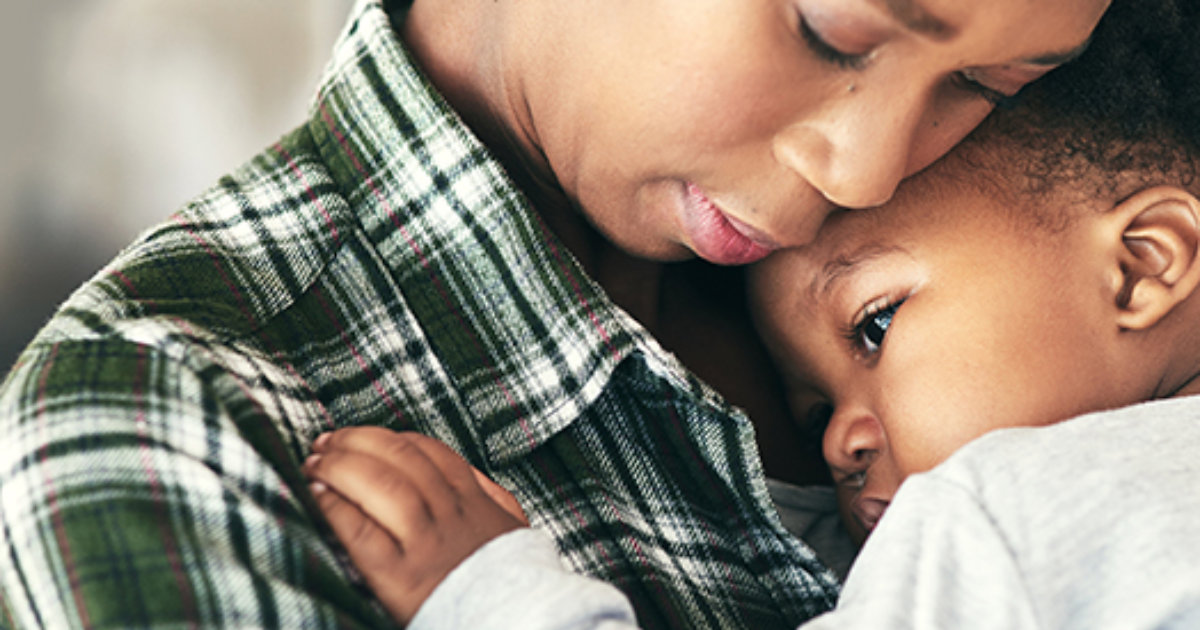 Woman holding her young son