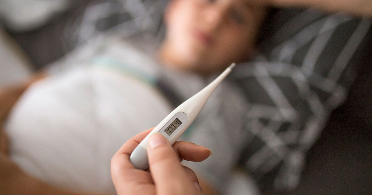 picture of a somebody checking a child's temperature