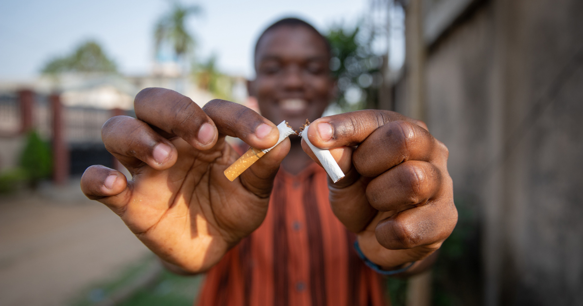 Man breaking a cigarette in half