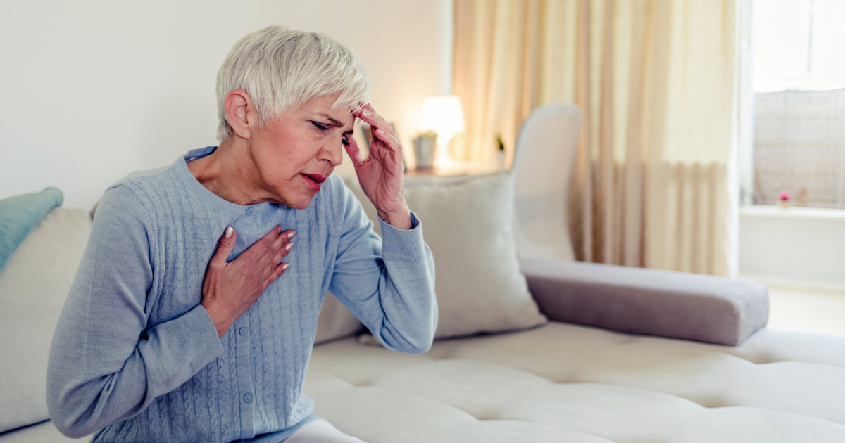 Older woman holding her heart and head