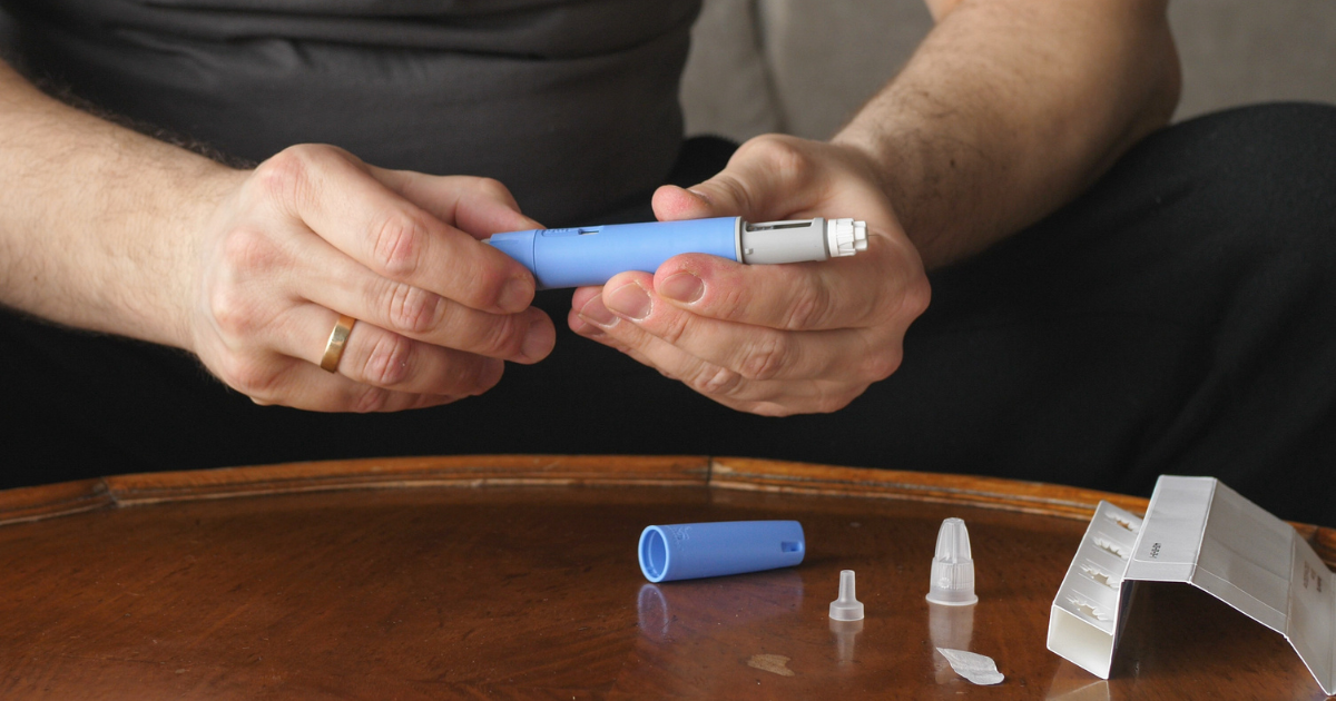 Man holding a semaglutide injection