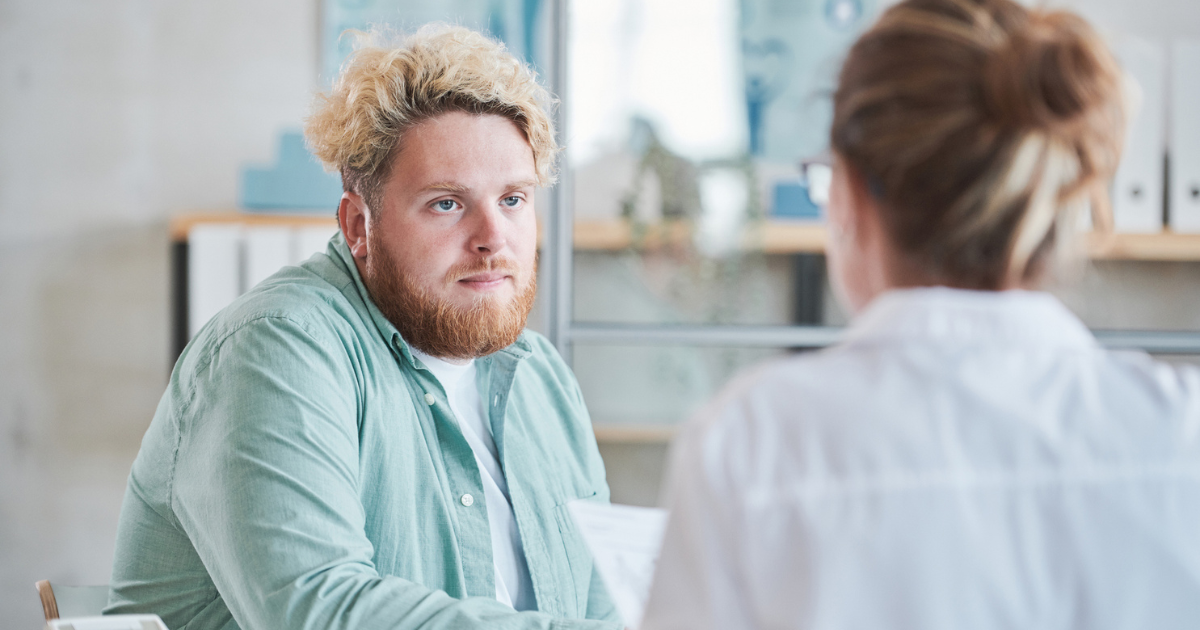 Man sitting, speaking to his doctor