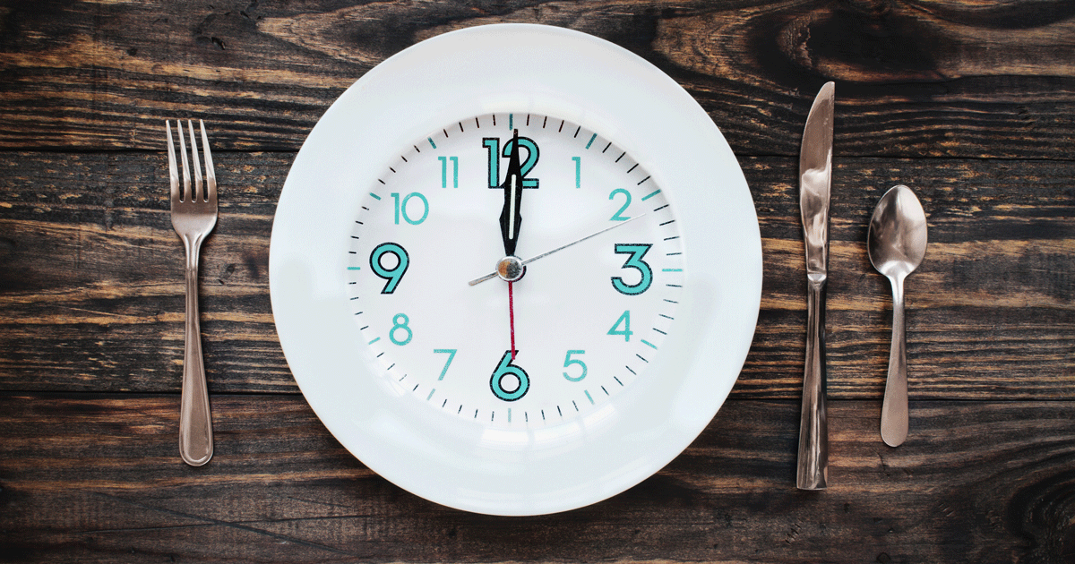 Fork and knife next to a clock