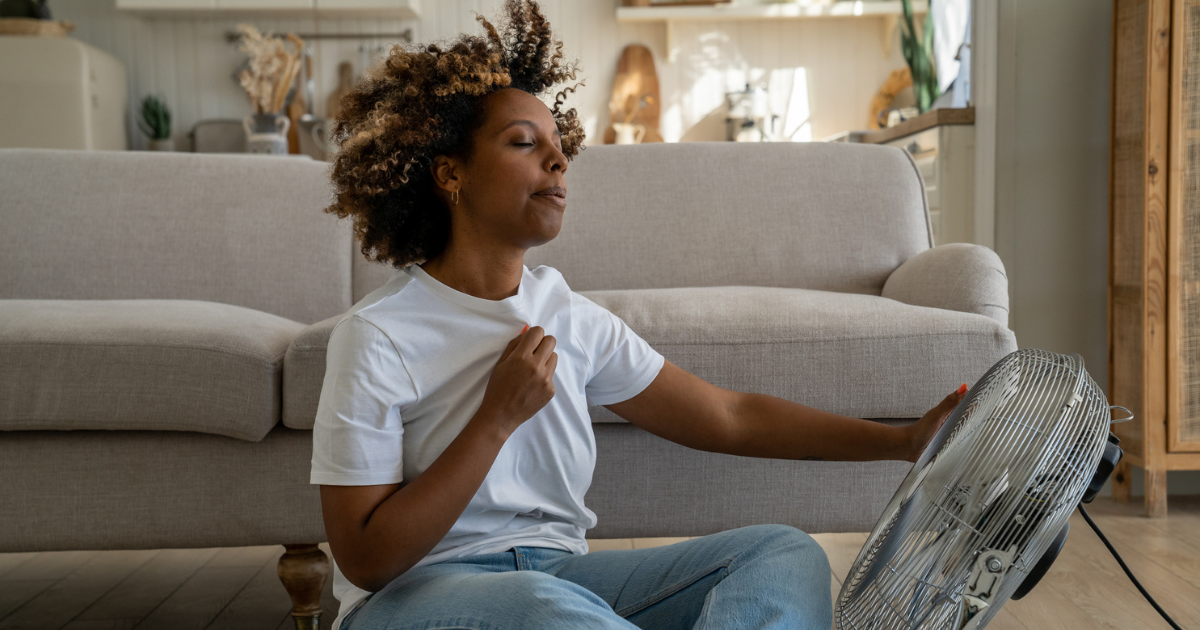 Woman sitting in front of a fan