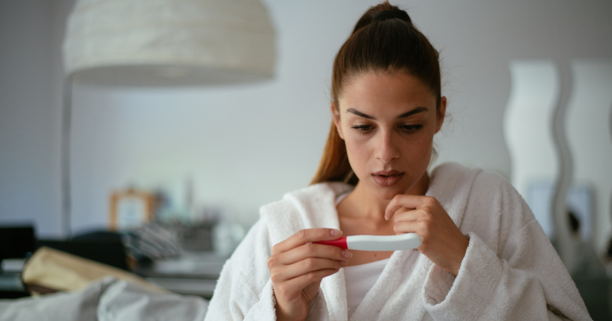 Young woman holding a pregnancy test