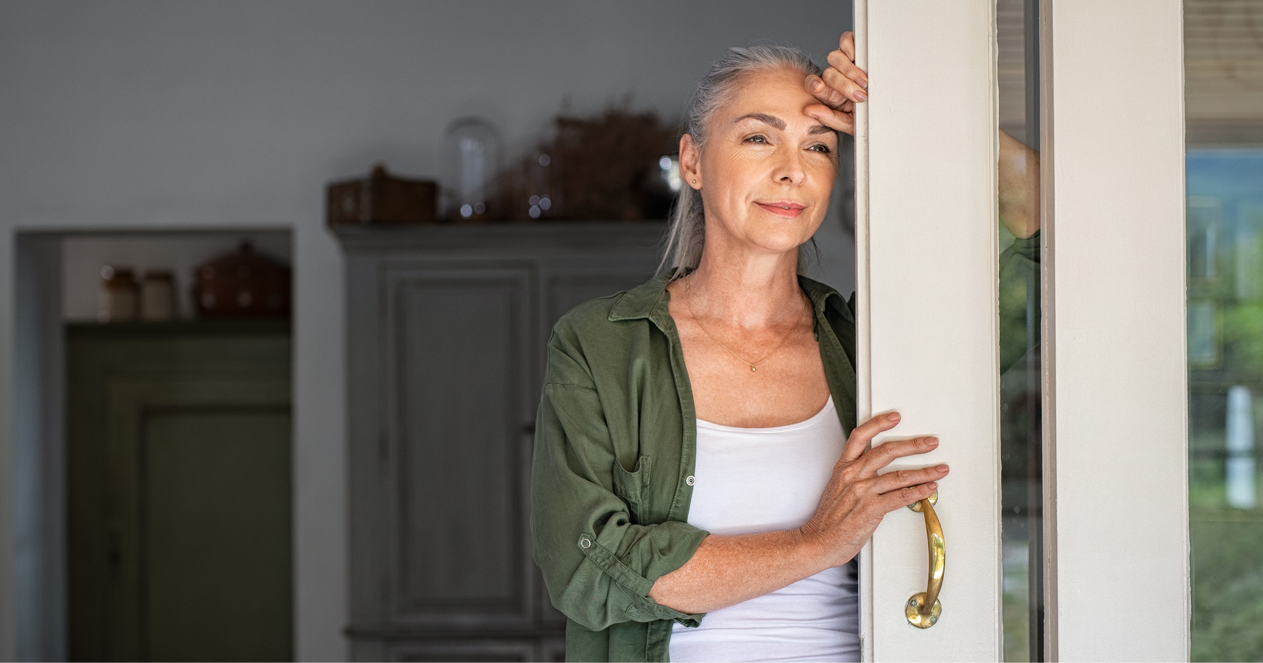 picture of a woman looking out a door