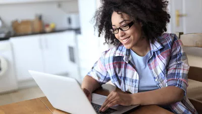 Woman looking up information on a laptop.