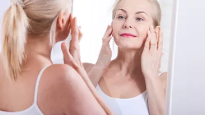 picture of a woman looking at herself in a mirror