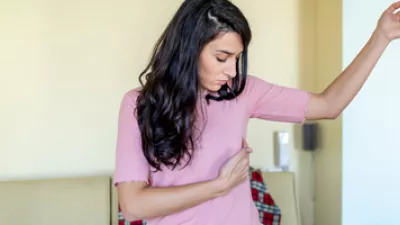 picture of a woman doing a self breast exam