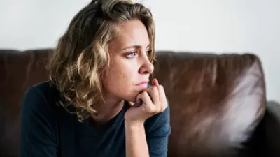 picture of a woman looking out her window