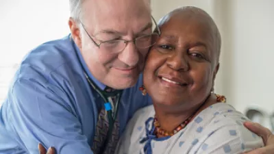 Kenneth Cowan, MD, PhD, pictured with one of his cancer patients